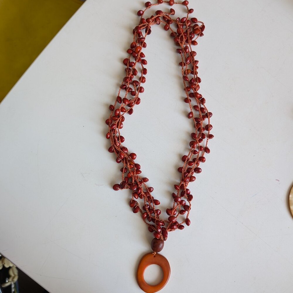 Orange and Red Statement necklace with seeds from the artists' home of Colombia